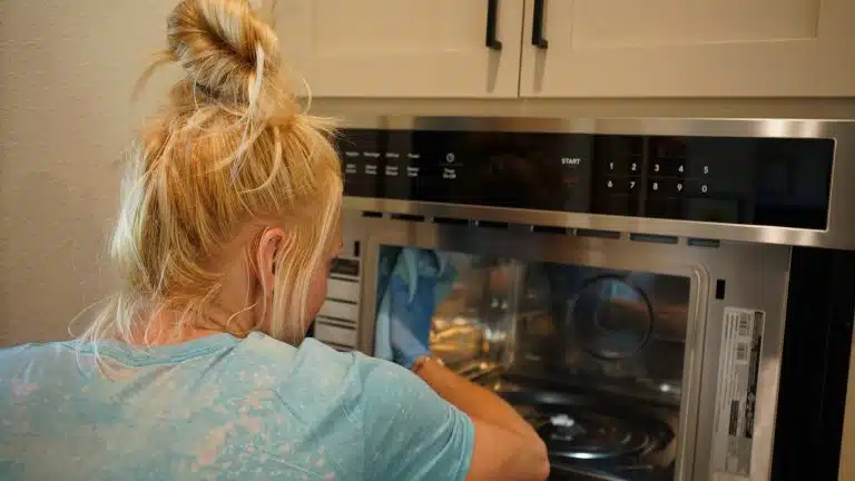 Simply Maid Sparkle Technician detailing the inside of a wall oven