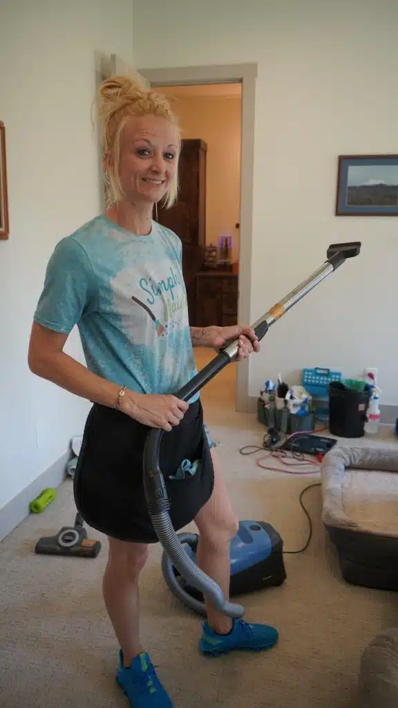 Simply Maid Sparkle Technician vacuuming a home